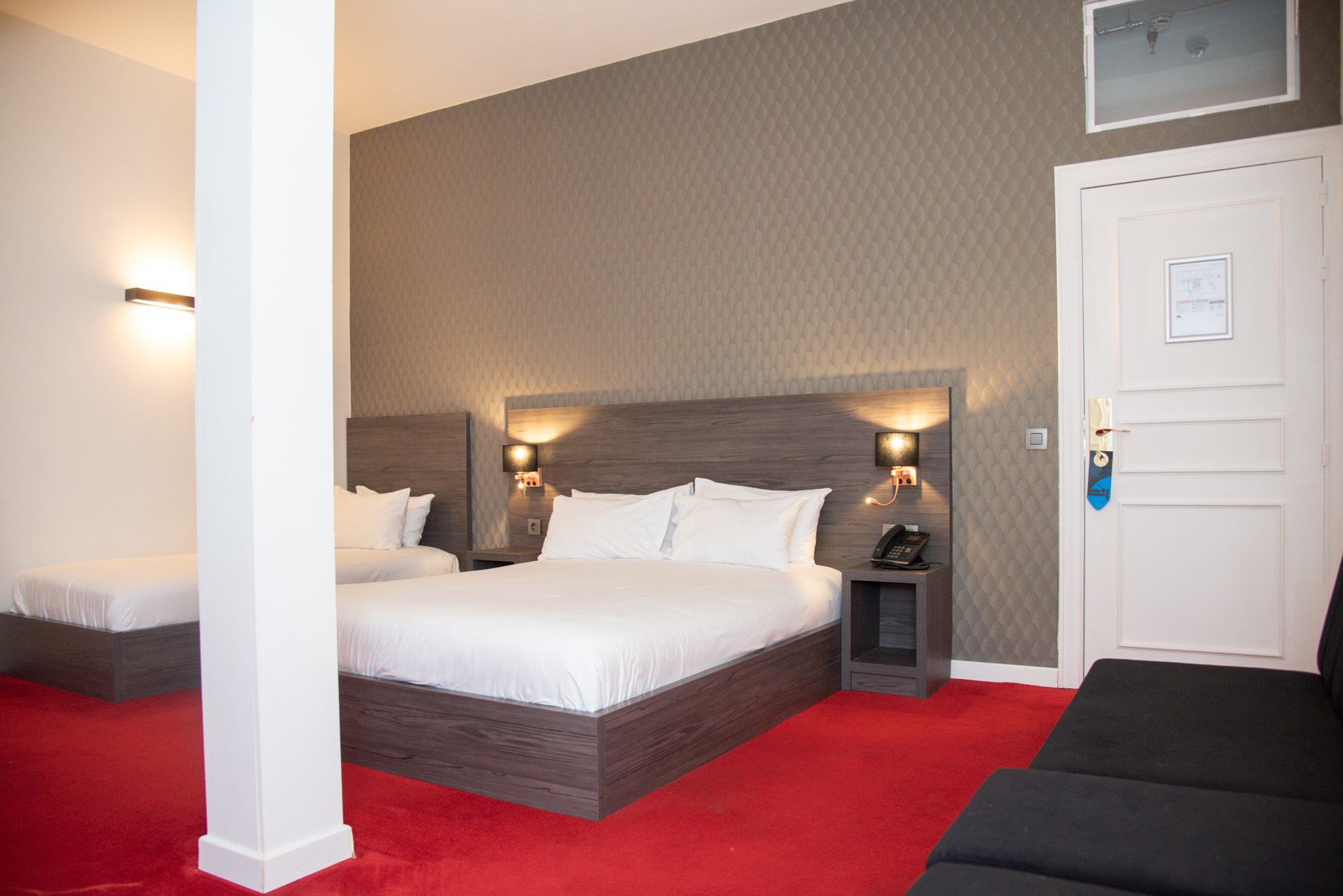 Family room for 6 people at La Bourse Hotel Brussels with multiple beds, spacious layout, and modern interior in city centre