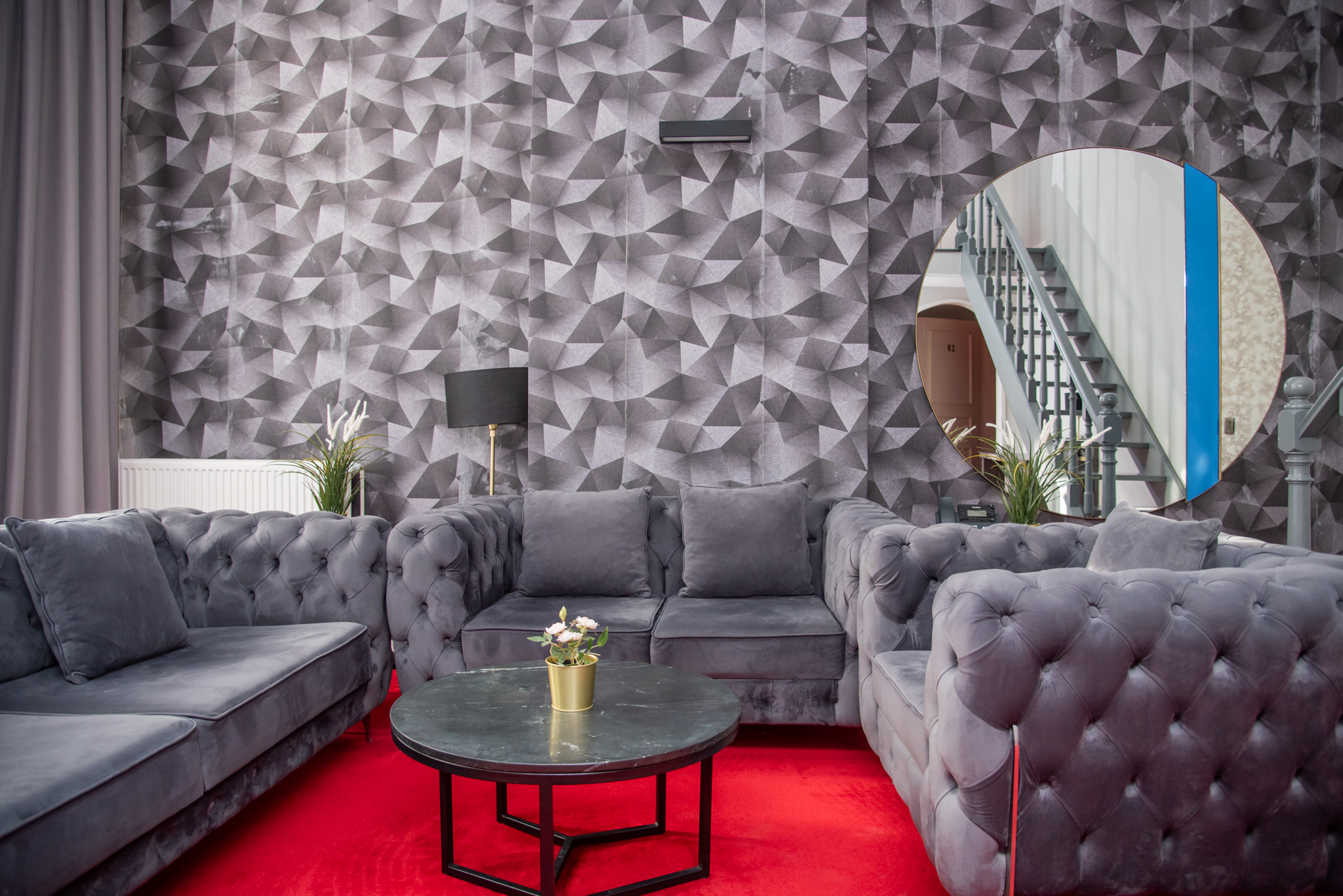 Suite room at La Bourse Hotel Brussels featuring sofa seating area, modern interior design, and comfortable bedding in central Brussels city centre