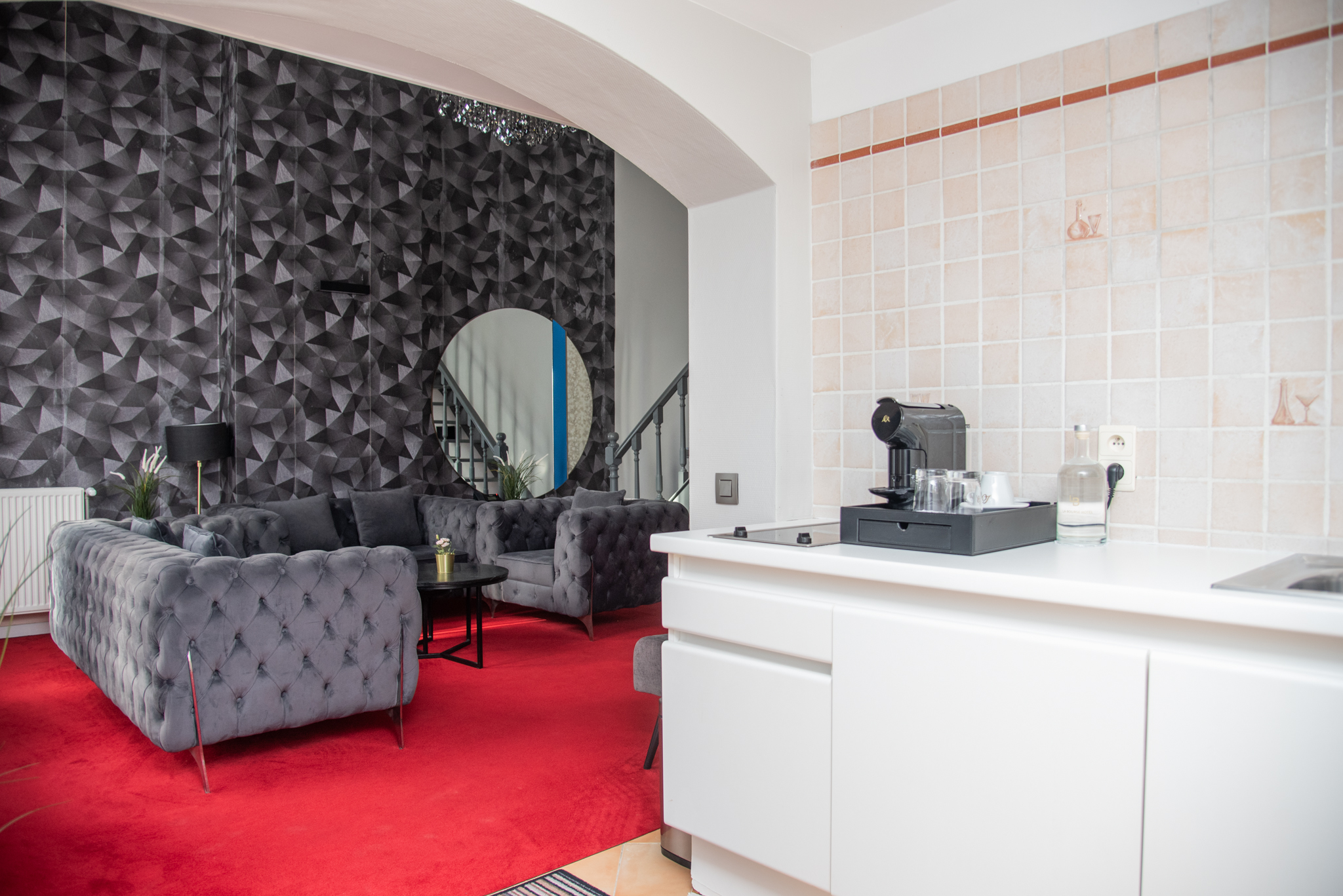 Suite room at La Bourse Hotel Brussels featuring sofa seating area, modern furnishings, and spacious interior in central Brussels city centre