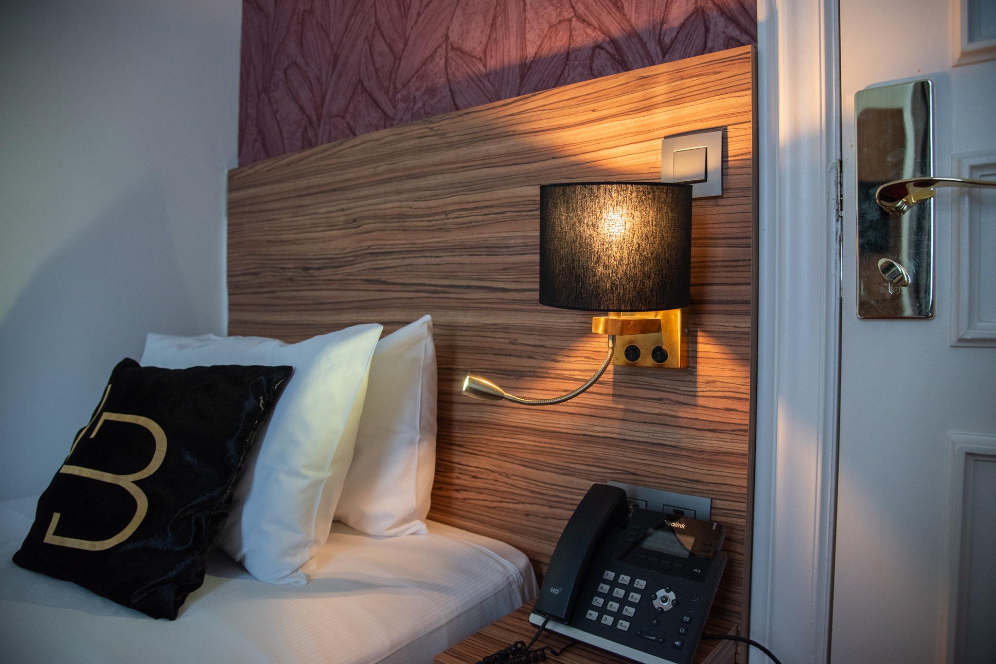 Single room at La Bourse Hotel Brussels with warm lighting, comfortable bed, and modern interior in central Brussels hotel