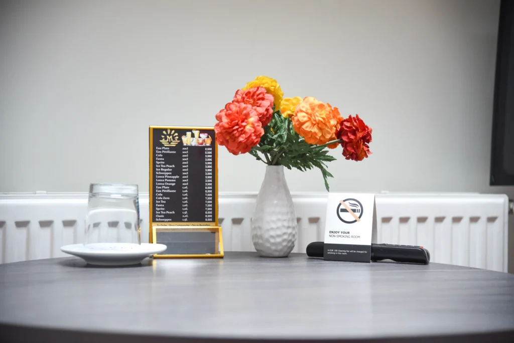 Guest experience at La Bourse Hotel Brussels showing room amenities including comfortable bedding, modern interior, and in-room facilities